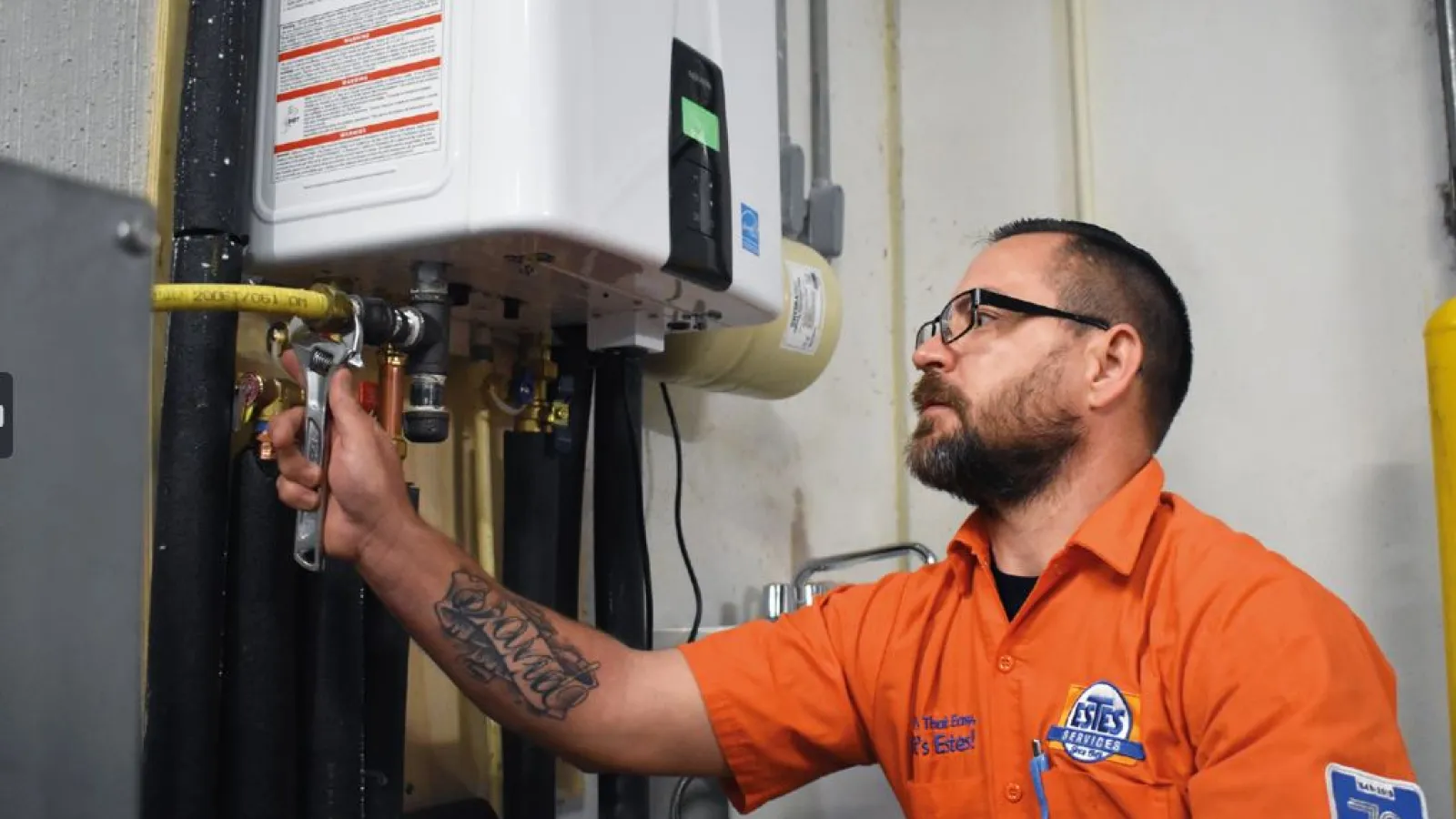 specialist repairing a hot water heater system