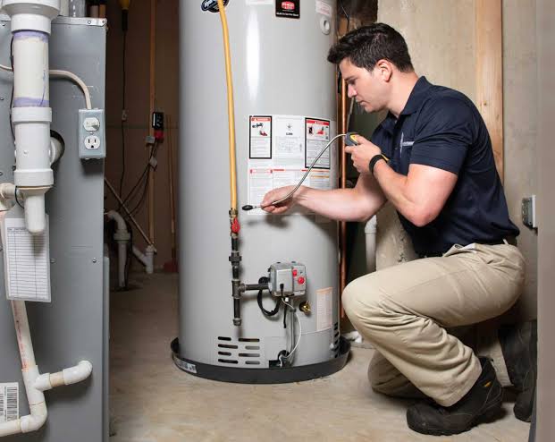 technician installing a hot water heater system
